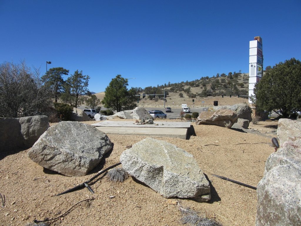 boulders encircle an empty concrete platform