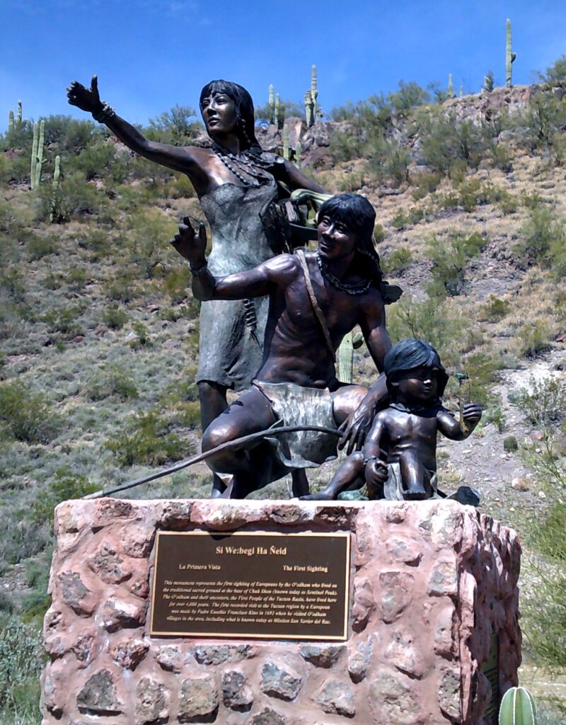 Bronze statue of standing woman, squatting man, and seated toddler